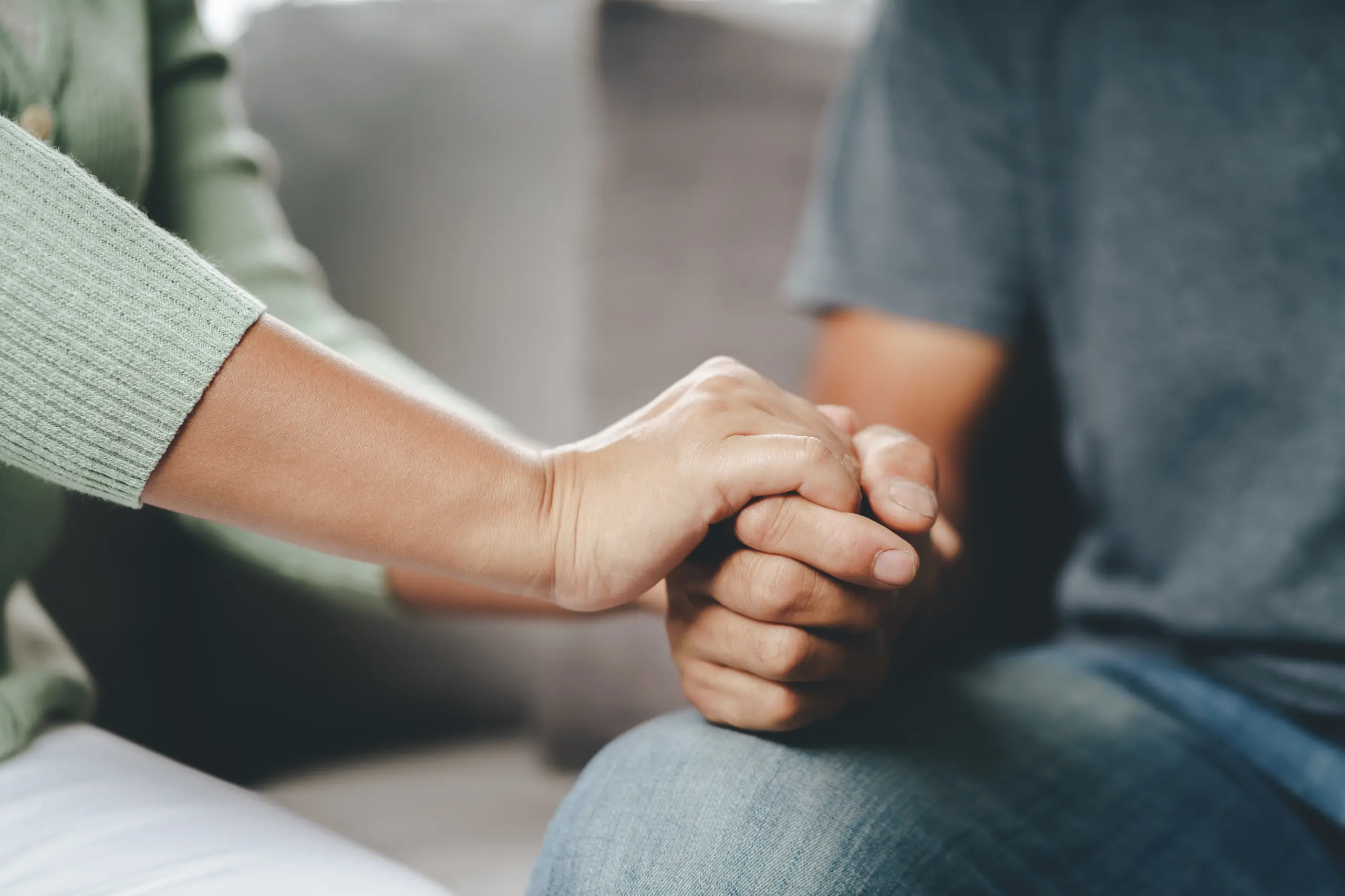 Female Friend Or Family Sitting And Hold Hands During Cheer Up To Mental Depress Man, Psychologist Provides Mental Aid To Patient. Ptsd Mental Health Concept.